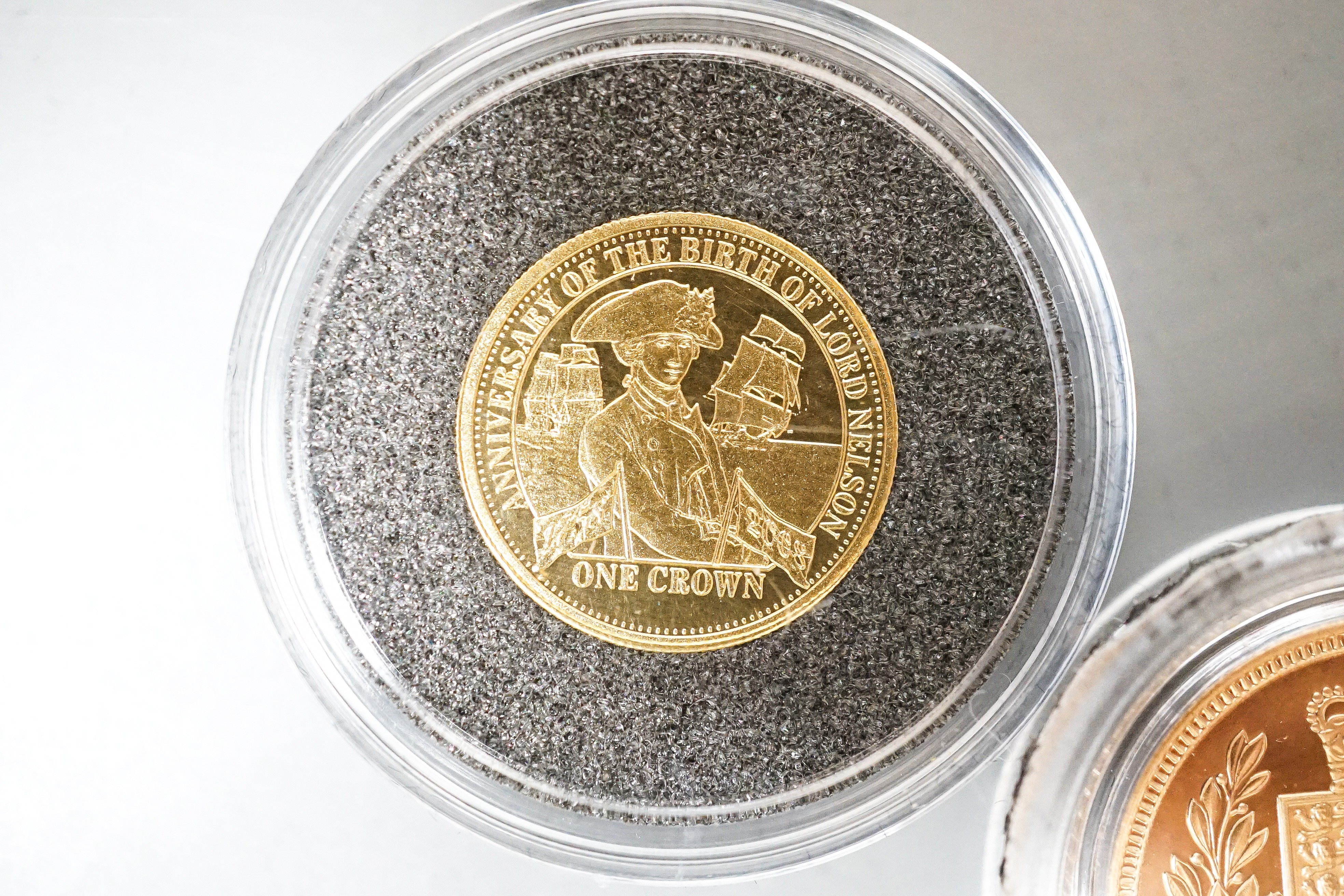 A Queen Elizabeth II gold proof half sovereign 2002 and a London mint Tristan Da Cunha gold piedfort one crown, cased with certificates (2)